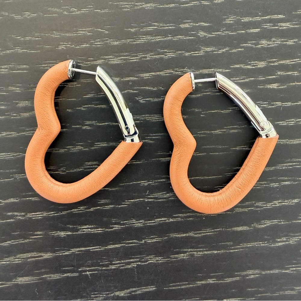 Hermes leather heart earrings in gold leather with silver hardware, never worn